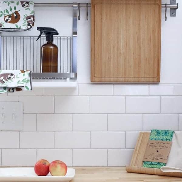 clean white kitchen with spray cleaner and cloths displayed