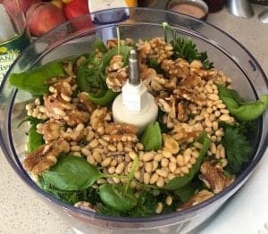 seeds and nuts with basil and parsley in the food processor