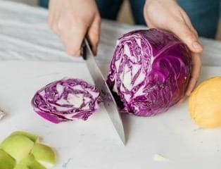 someone chopping red cabbage