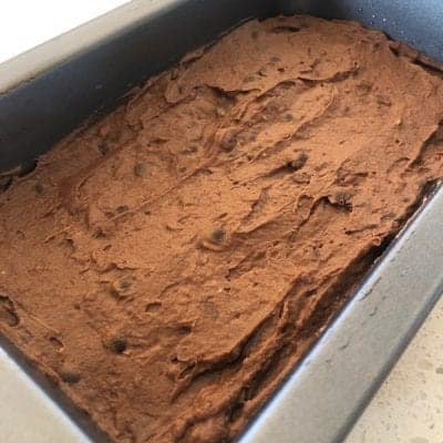 avocado brownie mixture spread within a baking dish