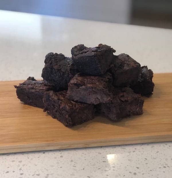 kumara avocado brownies chopped into squares on a wooden board