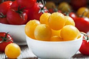 yellow and red tomatoes in white bowl
