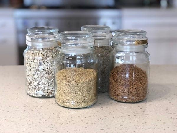 Four glass jars of tea that help to remove mucous. Marshmallow root, liquorice root, mullein and fenugreek
