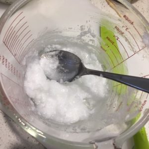 coconut oil softened in a glass jug