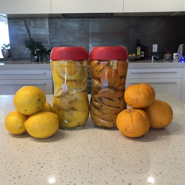 DIY super Citrus Spray cleaner being made in jars